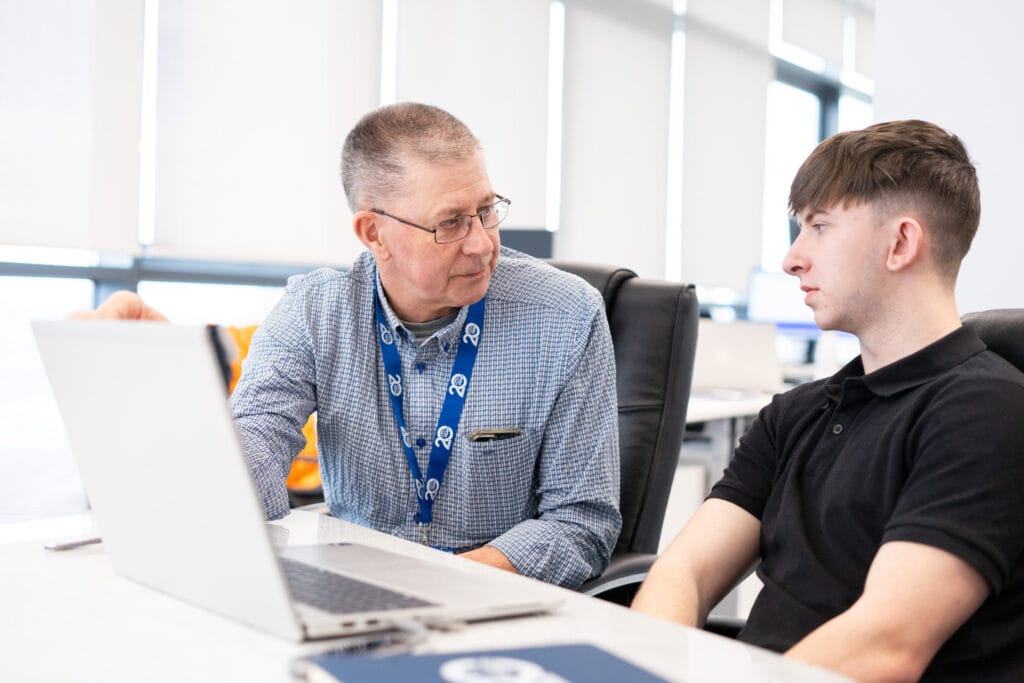 Mentorship for younger apprentices sat at desk
